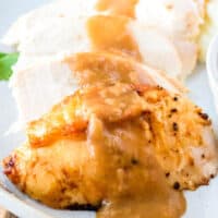 square image of air fryer turkey breast slices topped with gravy