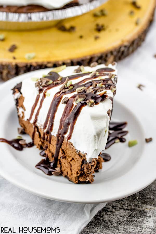 A slice of Andes Mint Pie on a plate and drizzled with chocolate sauce