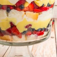 angel food cake berry trifle topped with a strawberry with recipe name at the bottom