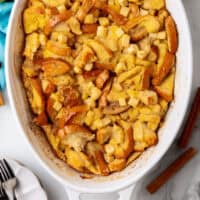 apple cinnamon baked french toast in a casserole dish with recipe name at the bototm