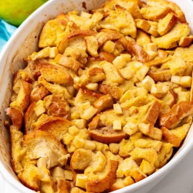 square image of apple cinnamon baked french toast in a baking dish