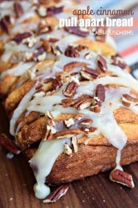 This easy APPLE CINNAMON PULL APART BREAD recipe is perfect for fall with baked apples, cinnamon sugar, and a sweet cream cheese glaze!