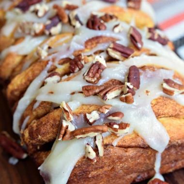 This easy APPLE CINNAMON PULL APART BREAD recipe is perfect for fall with baked apples, cinnamon sugar, and a sweet cream cheese glaze!