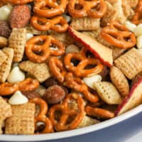 close up of apple cinnamon snack mix in a serving bowl with recipe name at the bottom