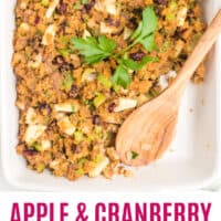 apple & cranberry cornbread dressing in a dish with a wooden spoon with recipe name at the bottom