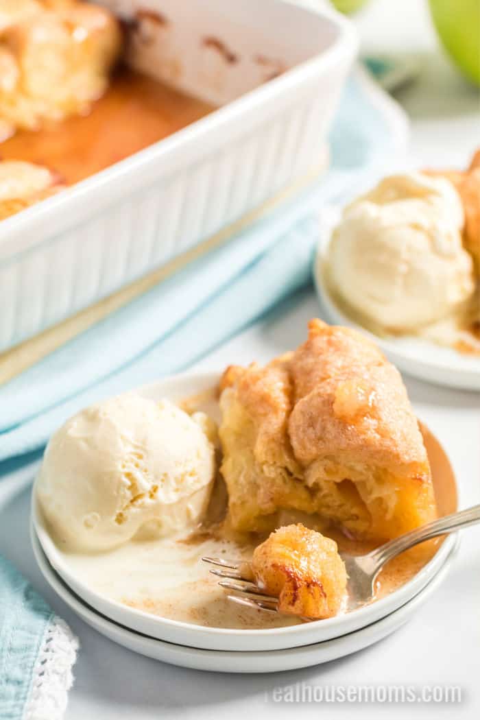 apple dumplings on a plate with a bite taken out