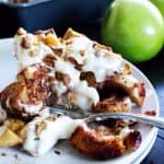 Apple Pie Cinnamon Roll Bake is an easy breakfast casserole with chunks of cinnamon rolls, apple, cinnamon, pecans and cream cheese icing!