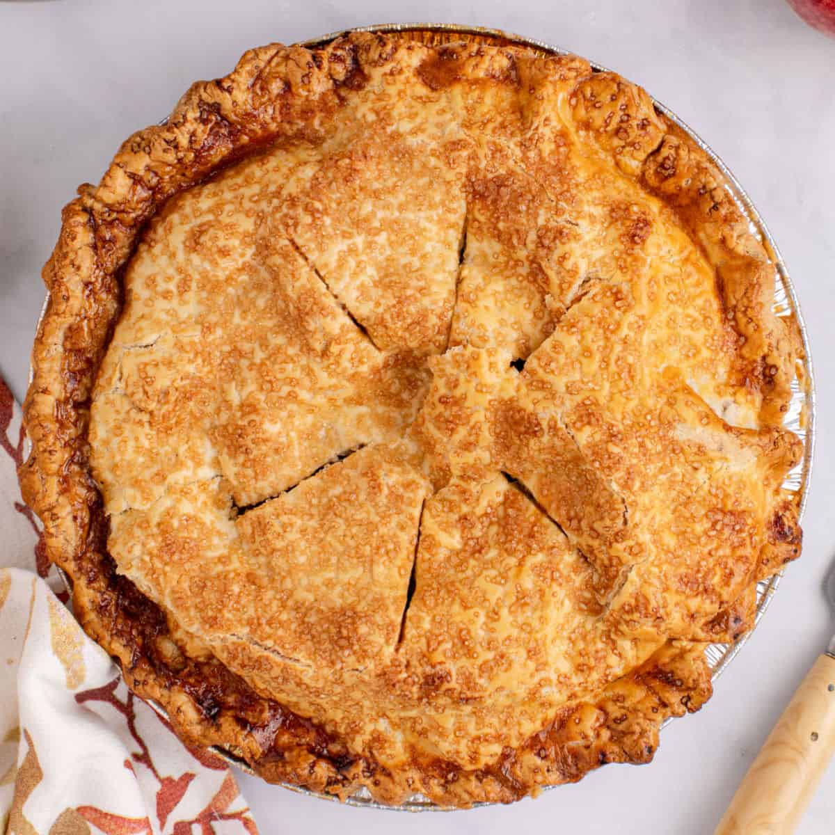 square image of a whole apple pie