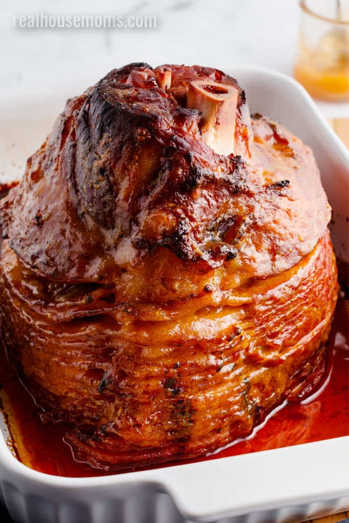 cooked glazed ham in baking pan