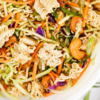 close up of asian ramen broccoli slaw in a bowl with recipe name at the bottom