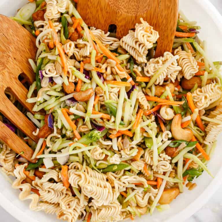 square image of asian ramen broccoli slaw with wooden serving claws