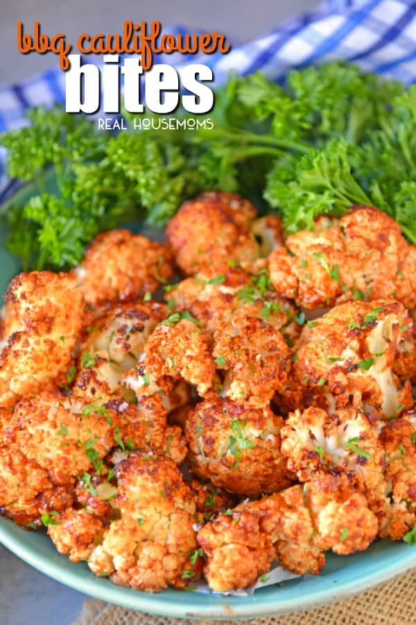 BBQ Cauliflower Bites piled up on a serving plate over kale leaves