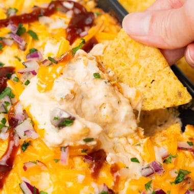 square image of a tortilla chip being dipped into a dish of bbq chicken dip