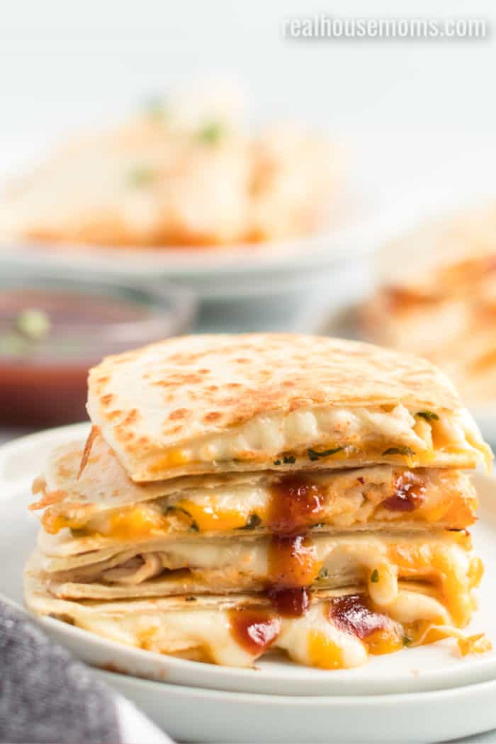 chicken quesadilla slices stacked up and drizzled with bbq sauce