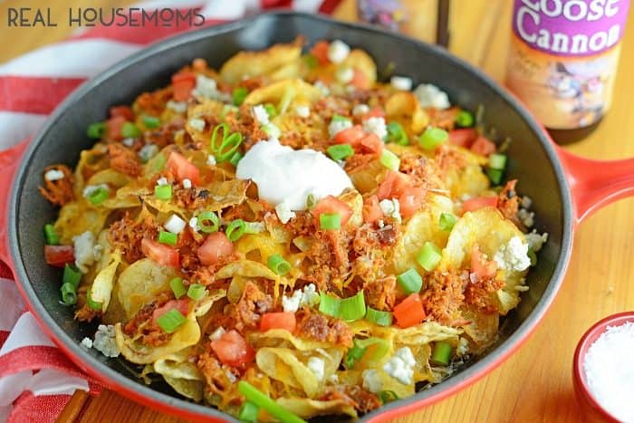 PULLED PORK POTATO CHIP NACHOS are a new twist on an old favorite! Crispy kettle chips, tangy BBQ & two cheeses make this is an appetizer everyone will enjoy!
