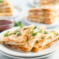 BBQ Chicken Quesadillas are a fun twist on a delicious pizza! Stuffed with shredded chicken, lots of cheese, and BBQ sauce they’ll be the star of any party!