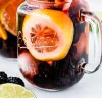 mason jar glass with blackberry sangria with recipe name at bottom