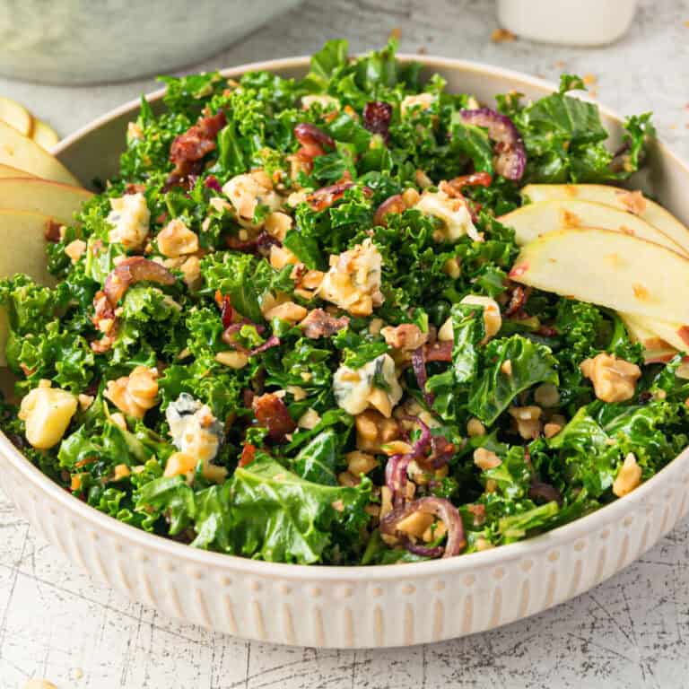 square image of bacon blue cheese kale salad in a shallow bowl