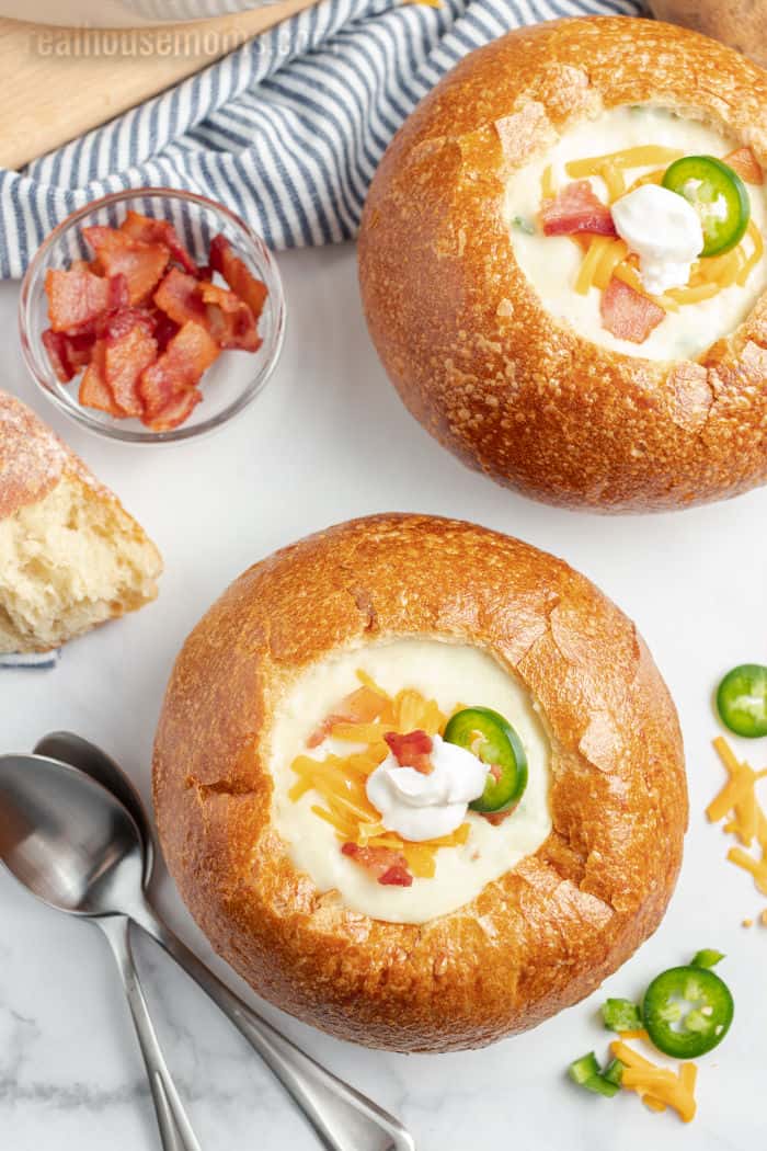 close up of baked potato soup in bread bowls
