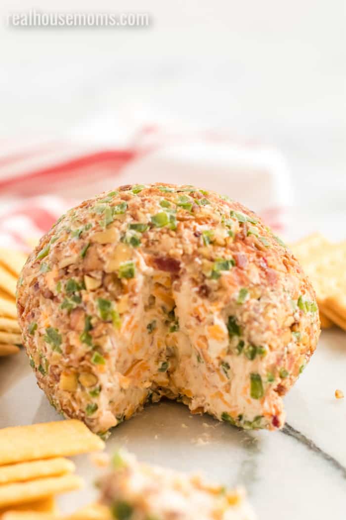bacon jalapeno cheese ball with a slice cut out