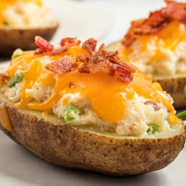 Bacon Jalapeno Popper Twice Baked Potatoes combine the amazing flavors of bacon, cheese, jalapenos, and potatoes! How could you go wrong?