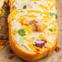 loaf of bacon ranch cheese bread on a baking sheet with recipe name at the bottom