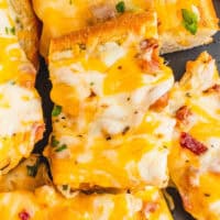 image of bacon ranch cheese bread slices stacked on a plate with the title of the post on top in pink and black lettering