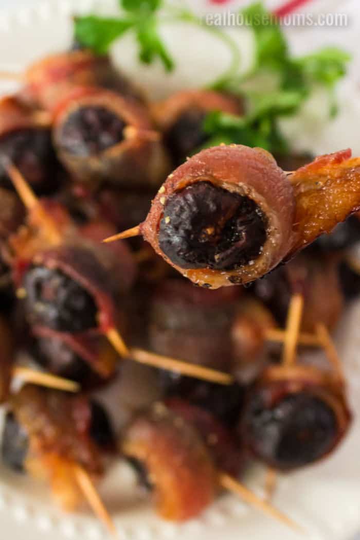 close up of a fig wrapped in cooked pepper bacon