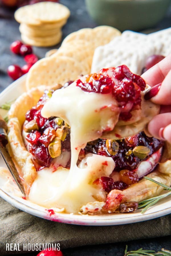 a cracker loaded with baked brie