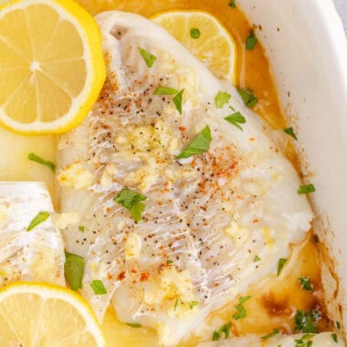 square image of baked cod in a baking dish after cooking
