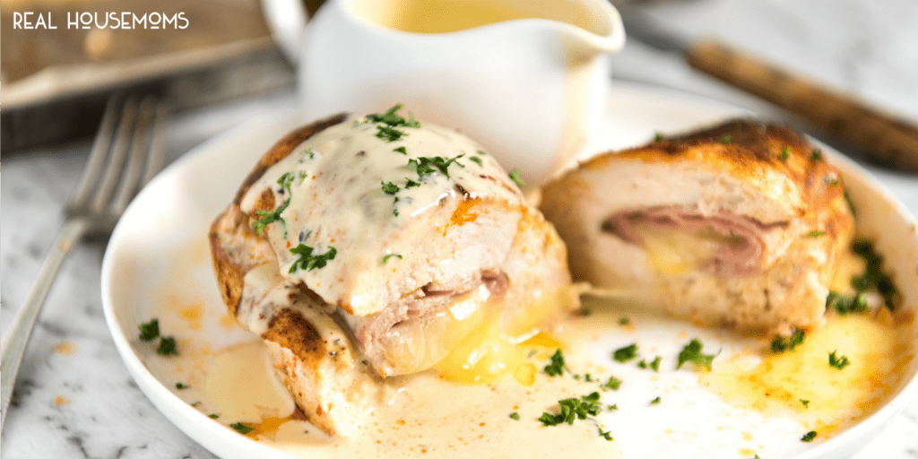 This Baked Ham and Cheese Stuffed Chicken is EPIC! Chicken breast stuffed with ham and cheese, then baked to juicy perfection and served with a simple yet wickedly delicious Mustard Cream Sauce. This is stellar for a quick midweek meal!