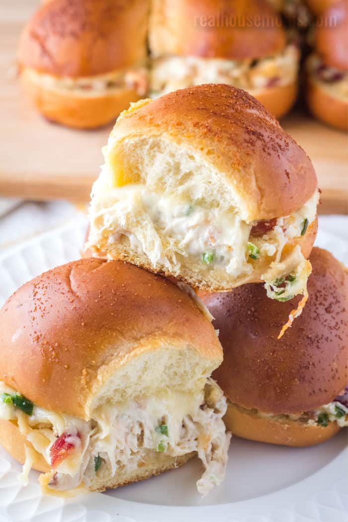 jalapeno popper chicken sliders stacked up on a plate