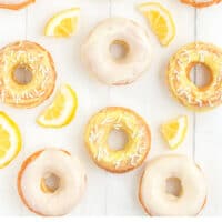 baked lemon donuts and lemon slices with recipe name at the bottom