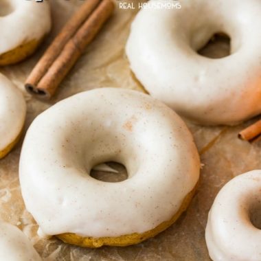 Soft and fluffy Pumpkin Spice Donuts covered in a buttery, seasonally spiced glaze frosting!  These donuts are baked, not fried, for a slightly lighter breakfast treat!