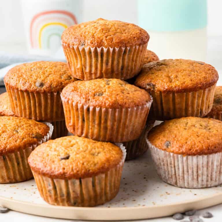 square image of banana chocolate chip muffins piled on a plate