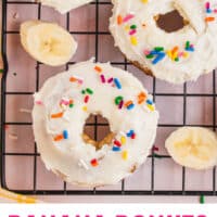 banana donuts with cream cheese frosting topped with sprinkles with recipe name at the bottom