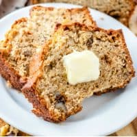 slices of banana nut bread on a plate with butter