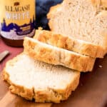 square image of a loaf of beer bread with slices cut from it