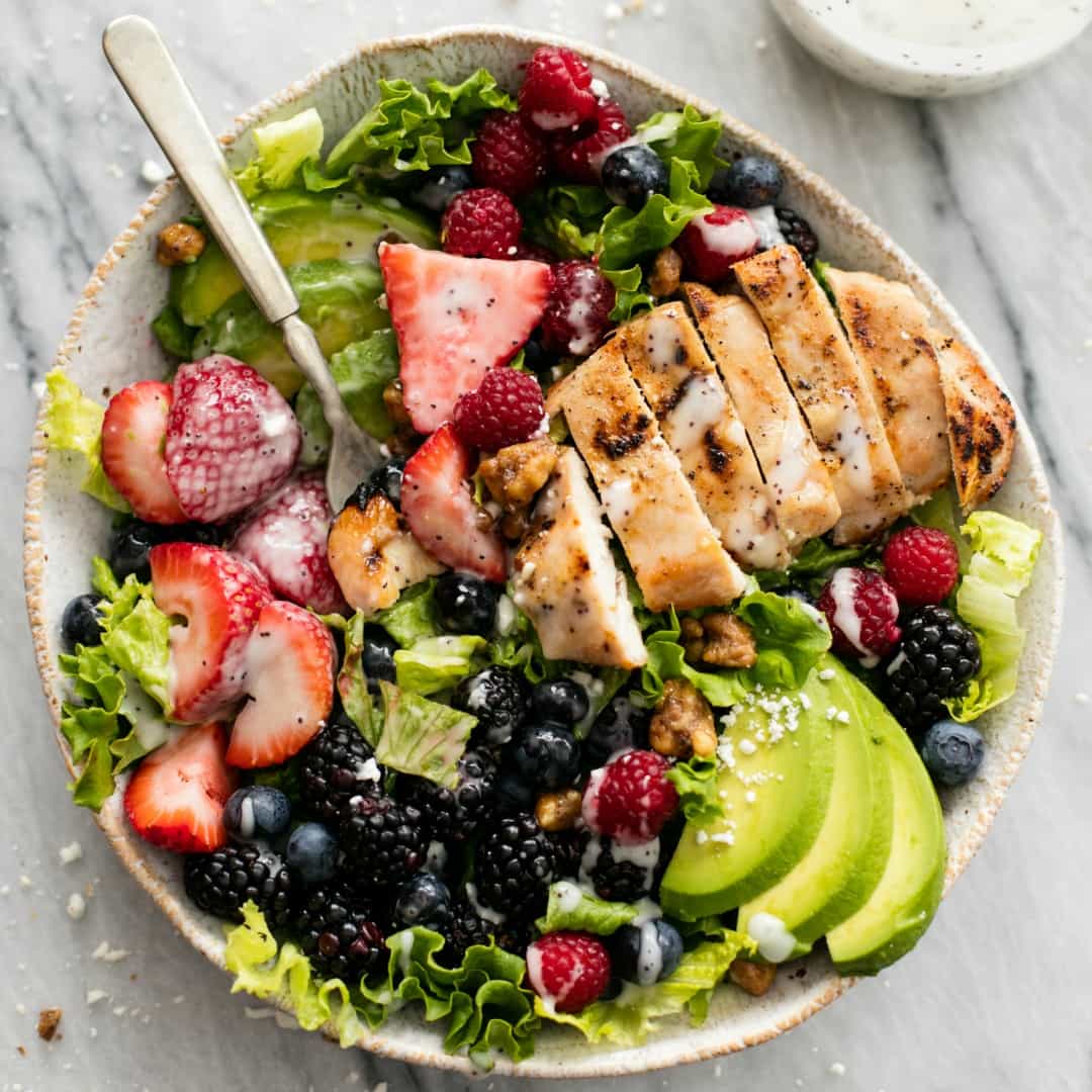 Easy and healthy Berry Avocado Grilled Chicken Salad is a cinch to whip up in just 30 minutes with incredible flavors and textures. The poppyseed dressing brings all of those flavors together in this yummy salad!