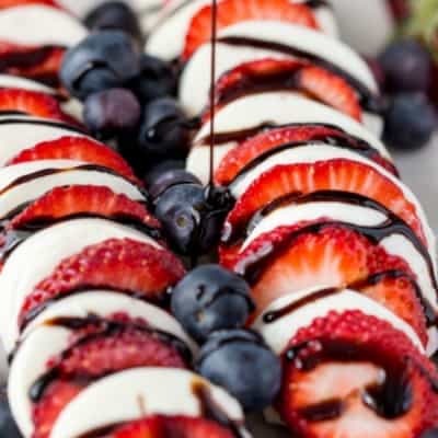 Red, white, and blue never tasted so good! The juicy berries, fresh mozzarella cheese, and balsamic reduction's sweet, syrupy goodness in this BERRY CAPRESE will have everyone coming back for more!