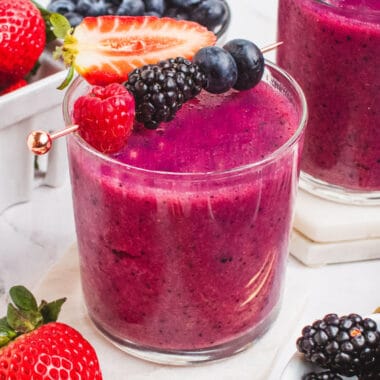 square image of a mixed berry smoothie in a short glass