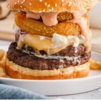 big daddy double cheeseburger with boom boom sauce on a plate with recipe name at the bottom