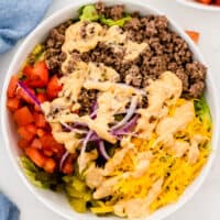 square image of big mac salad in a white serving bowl