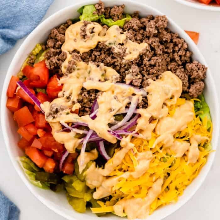 square image of big mac salad in a white serving bowl