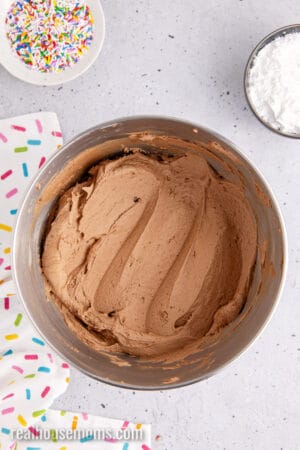 chocolate frosting in a stand mixer bowl after mixing