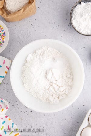 dry ingredients to homemade yellow cake in a mixing bowl