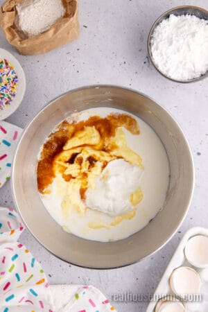wet ingredients for homemade yellow cake in a stand mixer bowl