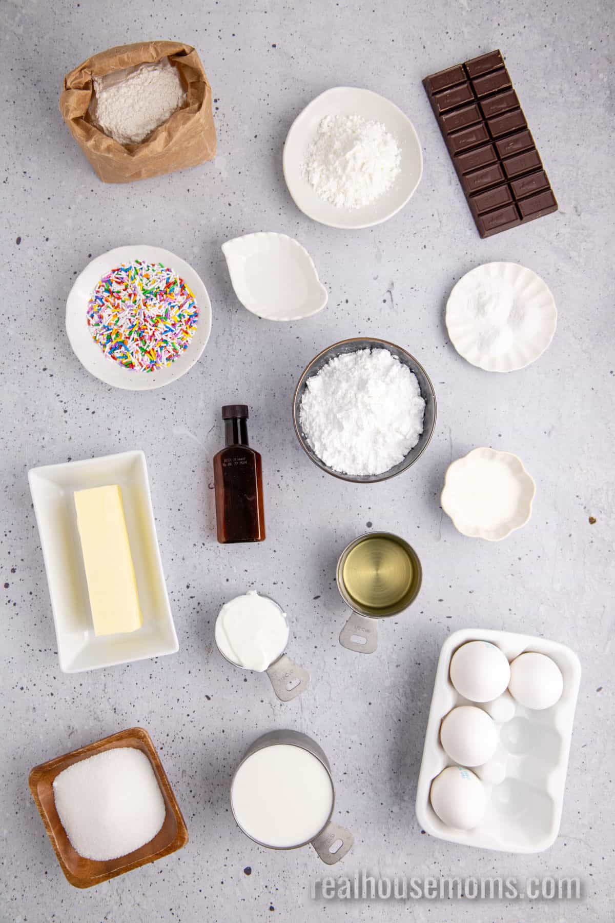 ingredients to make yellow cake and chocolate frosting laid out on a counter