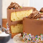 square image of a slice of birthday cake being taken from the rest of the cake