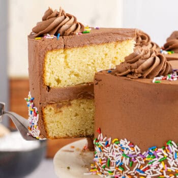 square image of a slice of birthday cake being taken from the rest of the cake